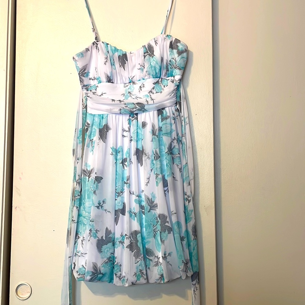 White floral dress. Spaghetti strap, A-Line cut. Size Medium. Dillard’s.